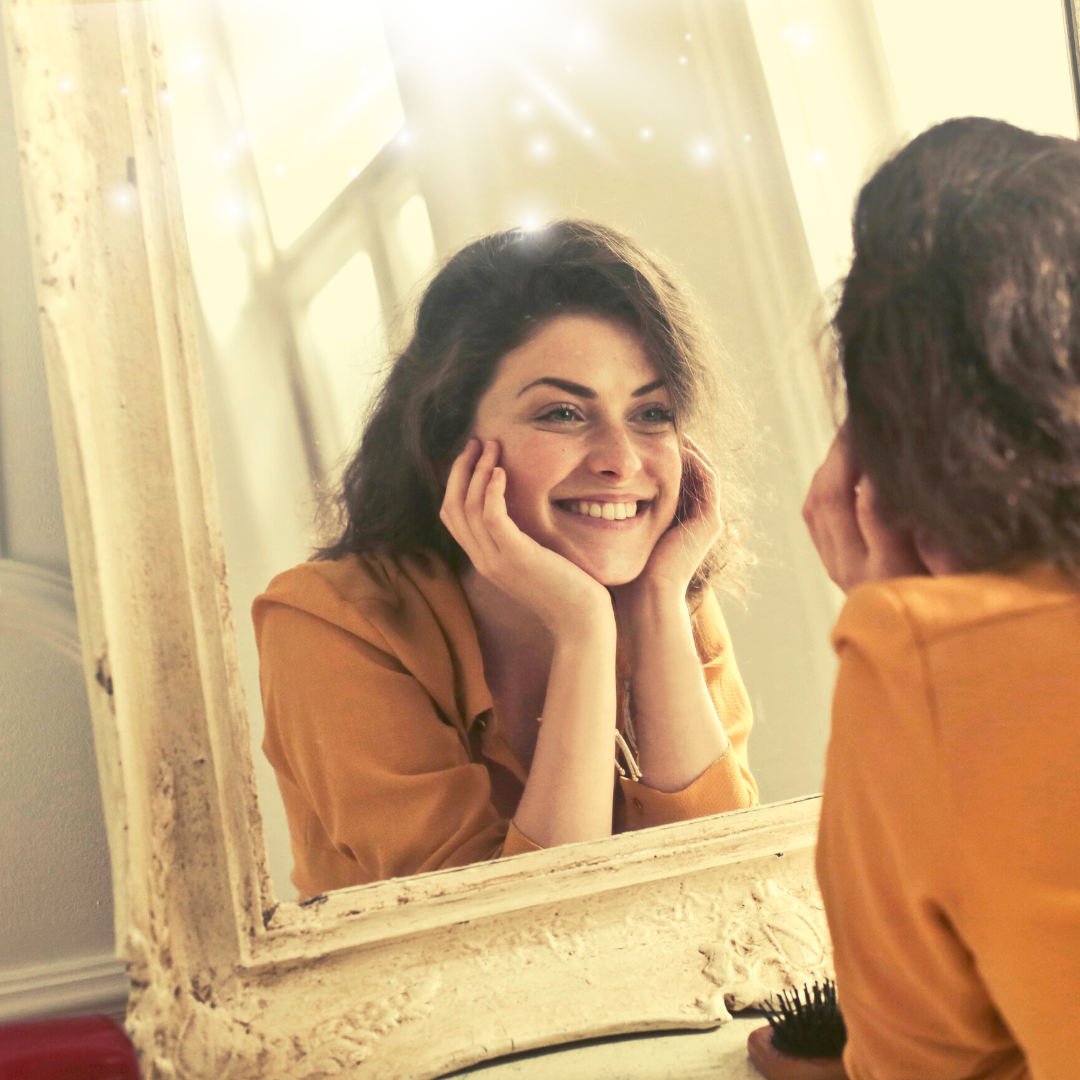 Smiling woman looking in a magic mirror